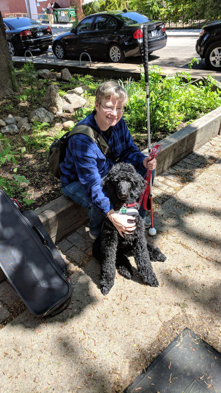 A picture of me and my service dog, Laddie, taken in March of 2018 (when he was about 4 months old -- he is MUCH larger now!).